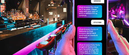 Sample text message over a bar/lounge setting background