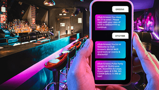 Sample text message over a bar/lounge setting background