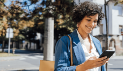 Person happily receives text message while out and about